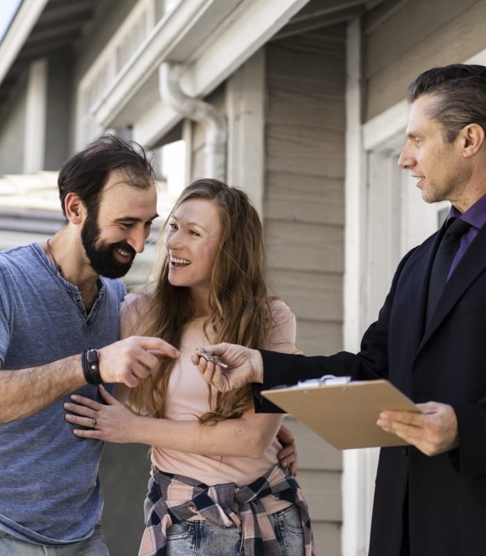 Couple signing papers for their new home purchase with mortgage broker in Surrey