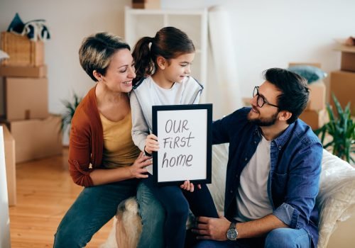 Happy parents and daughter celebrating their first home purchase with a mortgage broker in Surrey